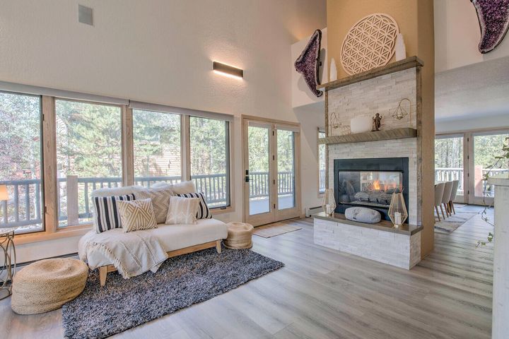 Great room with fireplace and floor-to-ceiling windows
