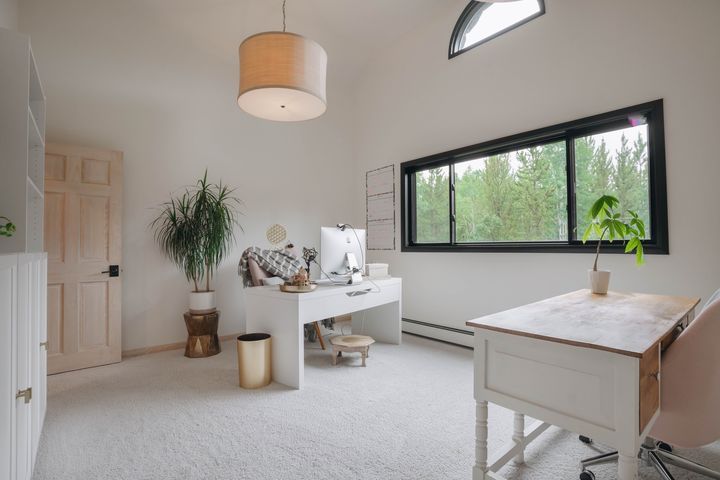 Office with two desks and forest views